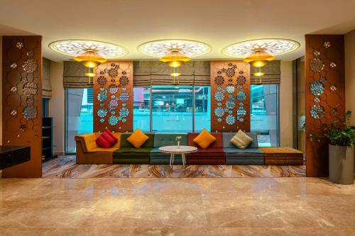 a living room with a couch and a table at Mercure Dubai Barsha Heights Hotel Suites And Apartments in Dubai