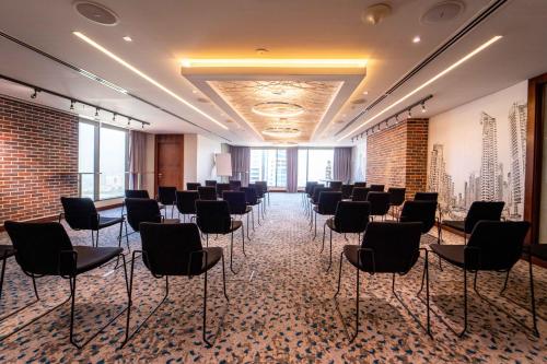 a room with rows of chairs in a room at Mercure Dubai Barsha Heights Hotel Suites And Apartments in Dubai