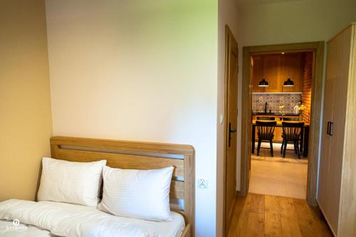 a room with a couch and a dining room at Zarębisko - noclegi całoroczne in Zwierzyniec