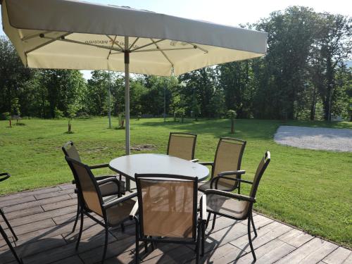 a table and chairs under an umbrella on a patio at Apartmány Štramberk in Štramberk