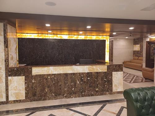 a lobby with a large screen on the wall at Hotel Benzz Park Chennai in Chennai