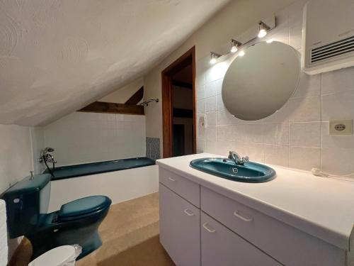 uma casa de banho com um lavatório, um WC e um espelho. em Sommette em Somme-Leuze
