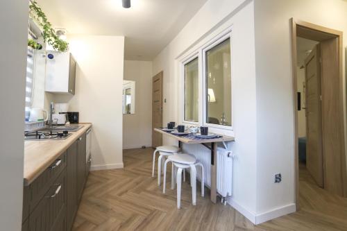 a bathroom with two sinks and a counter with stools at Apartament Żeromskiego 1 in Sandomierz