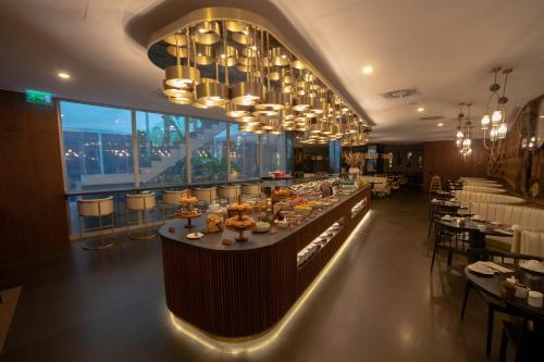 a restaurant with a long bar with tables and chairs at BessaHotel Liberdade in Lisbon
