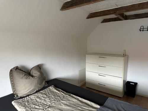 a bedroom with a bed and a dresser in it at Den gammel togstation in Give