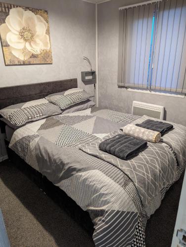 two beds in a bedroom with towels on them at 238b South shore in Bridlington