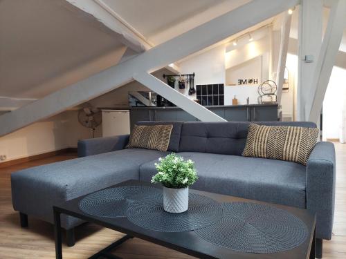 a living room with a blue couch and a table at Loft Cosy NICE centre ville in Nice