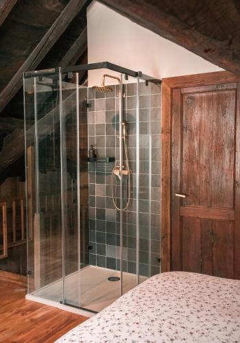 a shower with a glass enclosure in a bedroom at Casa rural Casa Bernat in Isil