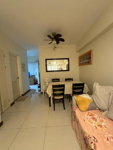 a living room with a table and a couch at 2BR Condo Unit at Prisma Residences in Manila