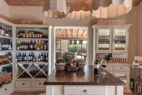a kitchen with a counter with bottles of wine at Locanda dell'Aioncino in Bibbona