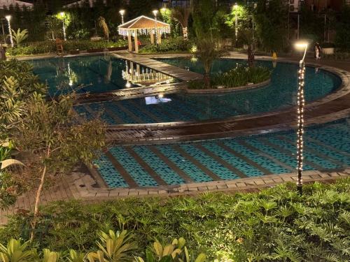 a swimming pool at night in a resort at 2BR Condo Unit at Prisma Residences in Manila
