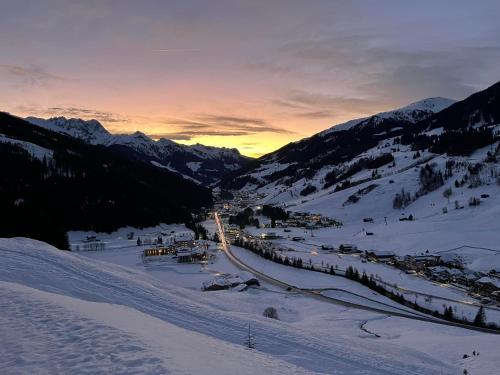 a ski resort in the snow at sunset at Gästehaus Hochstaffl in Gerlos