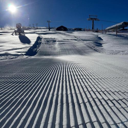 a snow covered road with tire tracks in the snow at Gästehaus Hochstaffl in Gerlos