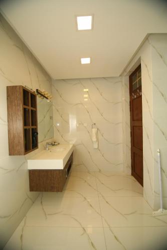 a bathroom with a sink and a mirror at Peshawar Barracks Hotel Estb-1867 in Peshawar