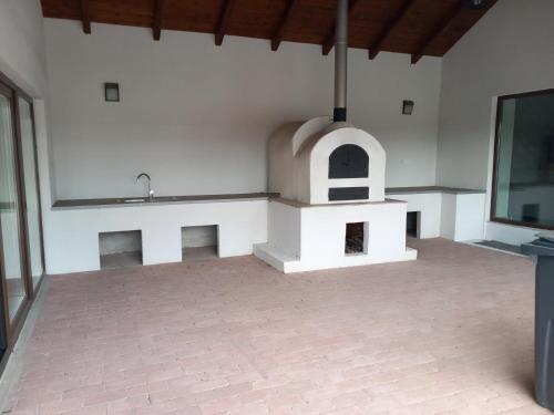 a kitchen with an outdoor oven in a room at Avalon Vendégház in Levelek