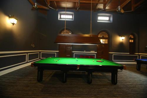 a pool table in a room with a fireplace at Peshawar Barracks Hotel Estb-1867 in Peshawar
