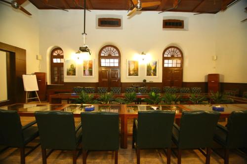 a dining room with a large table and chairs at Peshawar Barracks Hotel Estb-1867 in Peshawar