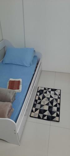 a bedroom with a bed with a checkerboardkered floor at VS HOSPEDAGEM in Cascavel