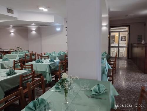 a dining room with green tables and chairs at HOTEL RISTORANTE SAN GIOVANNI in Falerna