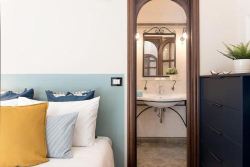 a bedroom with a sink and a bed with a mirror at Alassio Vayadu' Arabesque in Alassio