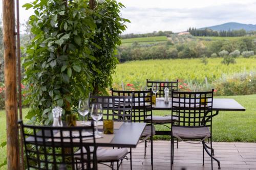 a group of tables and chairs on a patio at Locanda dell'Aioncino in Bibbona