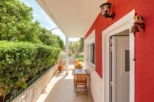 a balcony with a red and white house at Algés Village Casa 2 by Lisbon-Coast vacation in Algés