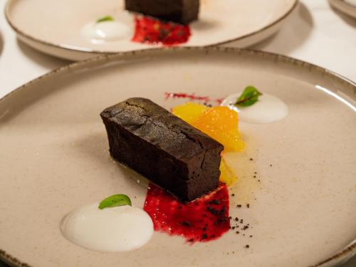 a piece of chocolate dessert on a white plate at ELITE HOTEL Nová Dubnica in Nová Dubnica