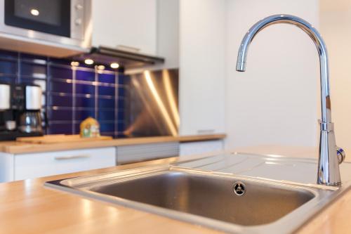 a stainless steel kitchen sink in a kitchen at Algés Village Casa 2 by Lisbon-Coast vacation in Algés