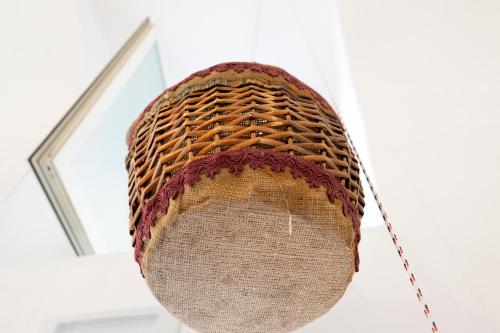 a wicker hat hanging from a ceiling at beb Da basso experience Napoli Toledo, Pompeii, Ercolano and Vesuvio in San Giorgio a Cremano