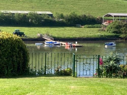 a group of boats floating on a river at Croak Cottage, Frogmore in South Pool