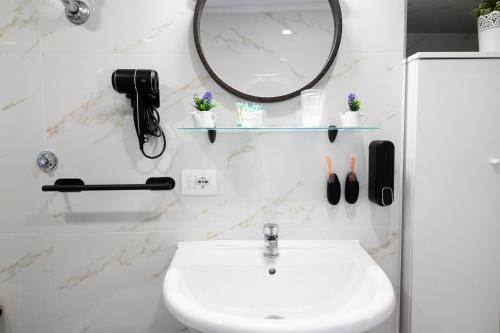 a bathroom with a sink and a mirror at beb Da basso experience Napoli Toledo, Pompeii, Ercolano and Vesuvio in San Giorgio a Cremano