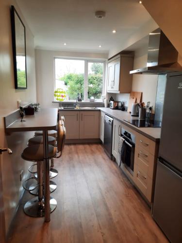 a kitchen with a table and a counter top at Croak Cottage, Frogmore in South Pool