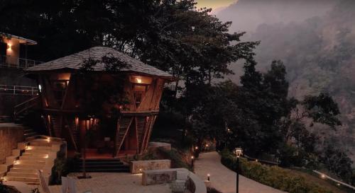 a gazebo with stairs and a view of a mountain at ONENESS Rishikesh by Ganga Kinare - A Luxury Wilderness Resort in Rishīkesh