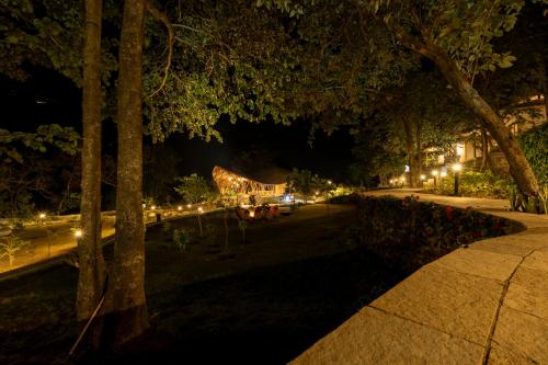a park lit up at night with lights at ONENESS Rishikesh by Ganga Kinare - A Luxury Wilderness Resort in Rishīkesh