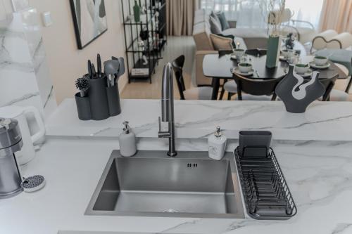 a kitchen sink with a faucet on a counter at Clever Guest Concorde JLT in Dubai