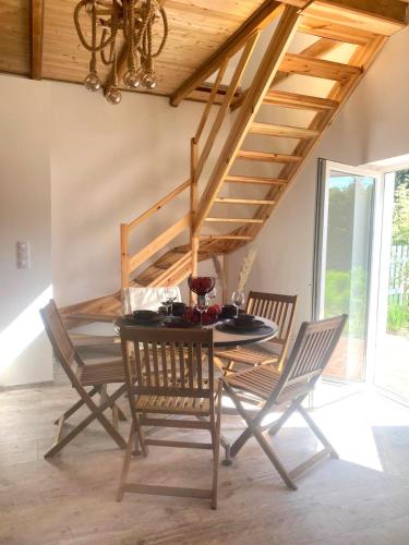 a dining room with a table and chairs at KURNIK - Domek pod lasem in Sztabin