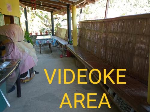 a group of benches in a room with the words videoarea at Jeremiah Homestay near Masasa Beach in Batangas City