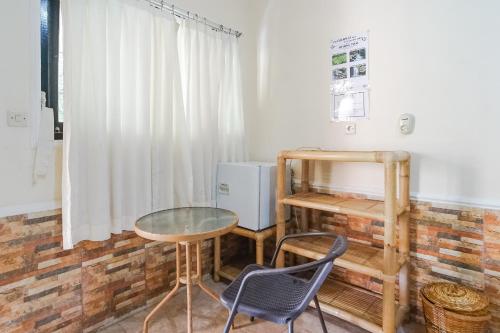 a table and chairs in a room with a window at Green View Ubud Hostel Bali in Ubud