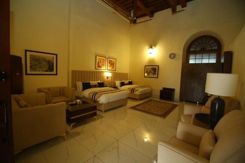 a large living room with a bed and a couch at Peshawar Barracks Hotel Estb-1867 in Peshawar