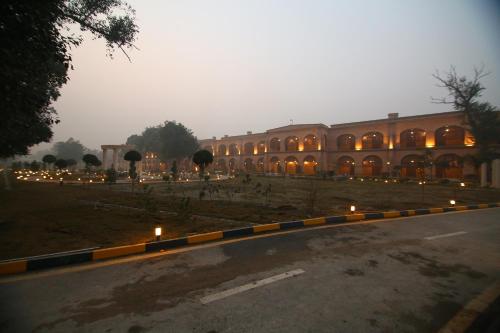a large building with lights in front of it at Peshawar Barracks Hotel Estb-1867 in Peshawar