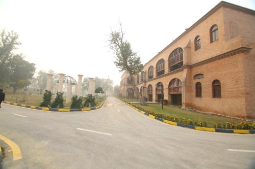 an empty street next to a brick building at Peshawar Barracks Hotel Estb-1867 in Peshawar