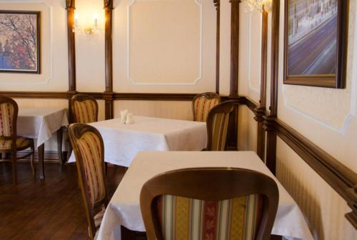 a restaurant with two tables and chairs with white tables at Europe in Solonka