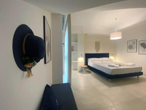 a bedroom with a bed and a couch at Corte Cesarina in Porto Cesareo