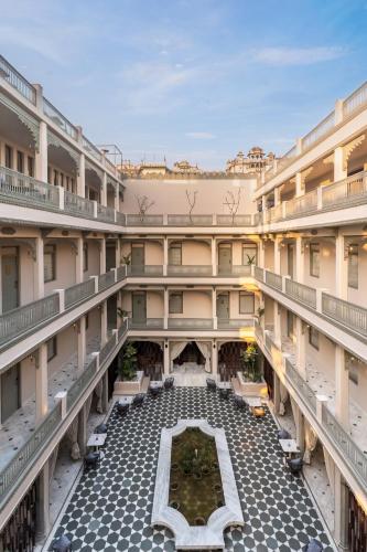 an empty courtyard of a building with a fountain at Manuscript - Jhilwara Haveli in Udaipur