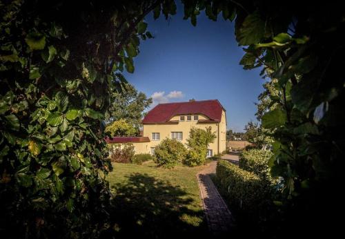 a large house with a red roof in a yard at Haus Silbermöwe in Mariendorf