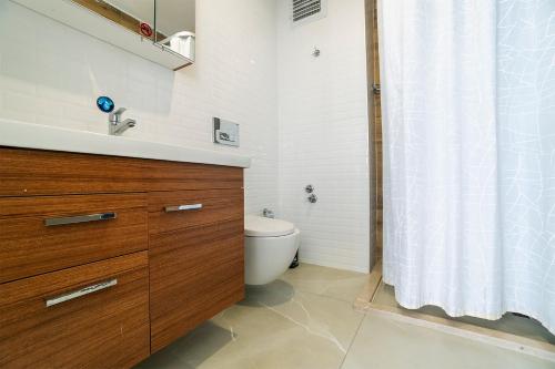 a bathroom with a toilet and a sink and a shower at Tut Hotel in Antalya