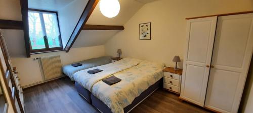 a small bedroom with a bed and a window at La Villonnière in Parnac