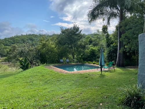 a swimming pool in the middle of a yard at Tjimaka Farm in Hazyview