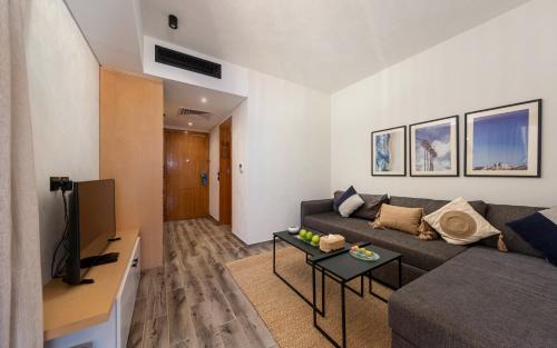a living room with a couch and a table at Creek Hotel and Residences El Gouna in Hurghada
