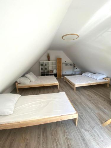 a room with three beds in a attic at KURNIK - Domek pod lasem in Sztabin